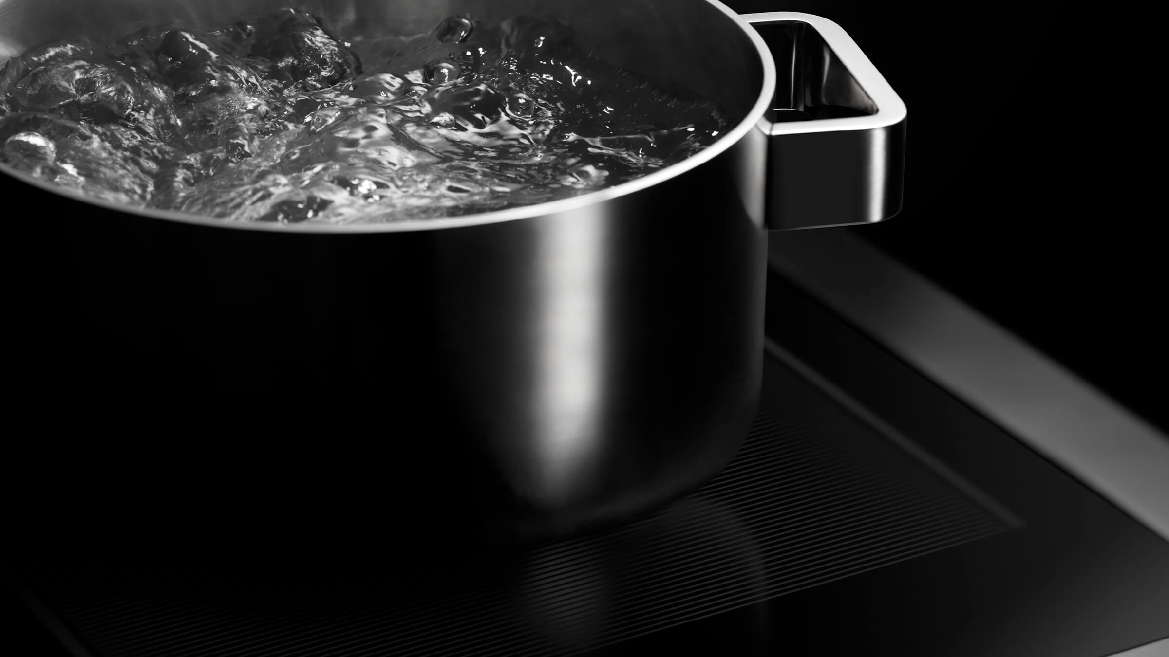 Modern kitchen with Fisher & Paykel freestanding cooker integrated into marble benchtop