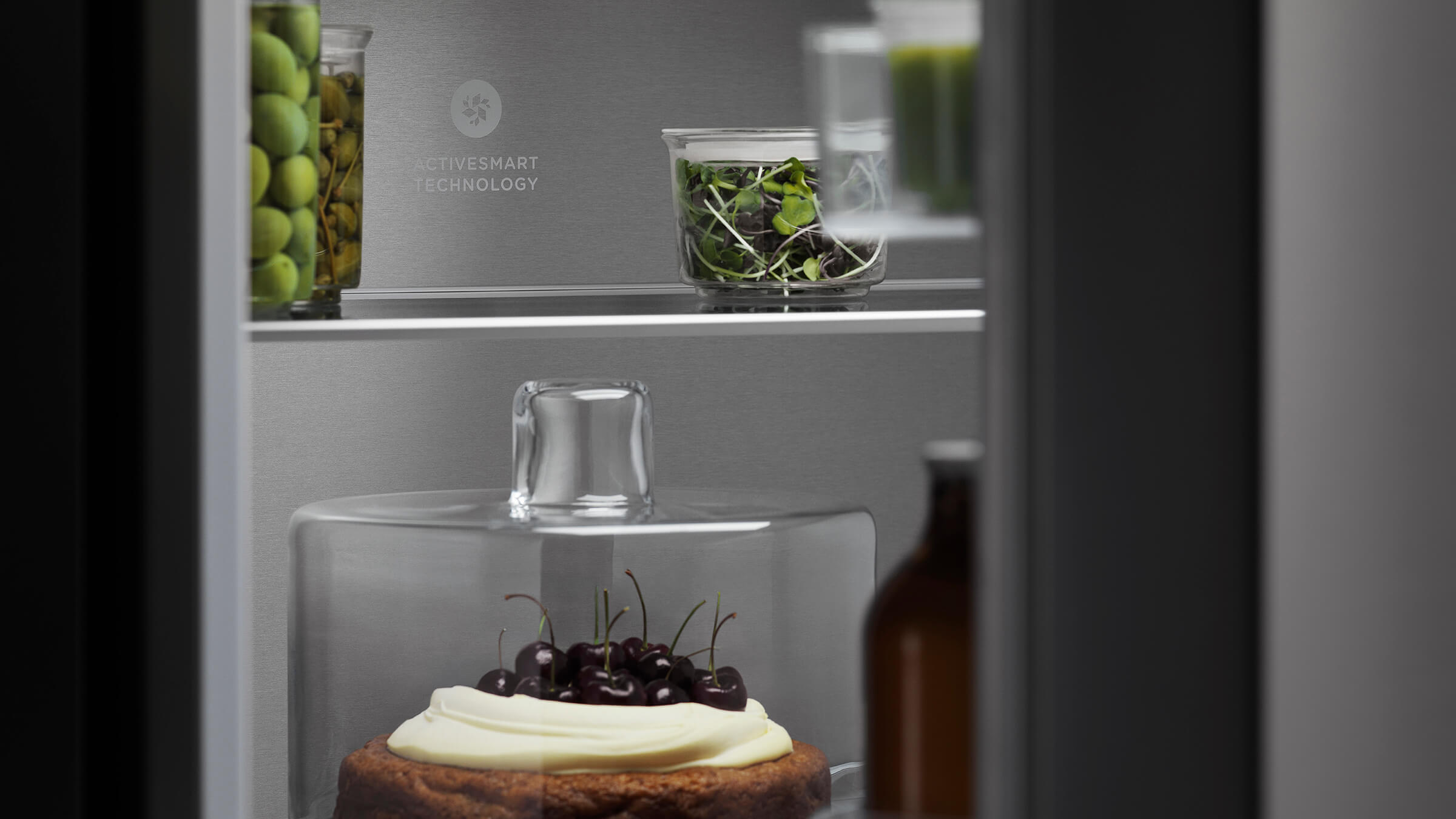 Interior detail of a bottom freezer refrigerator featuring ActiveSmart technology for optimal food care