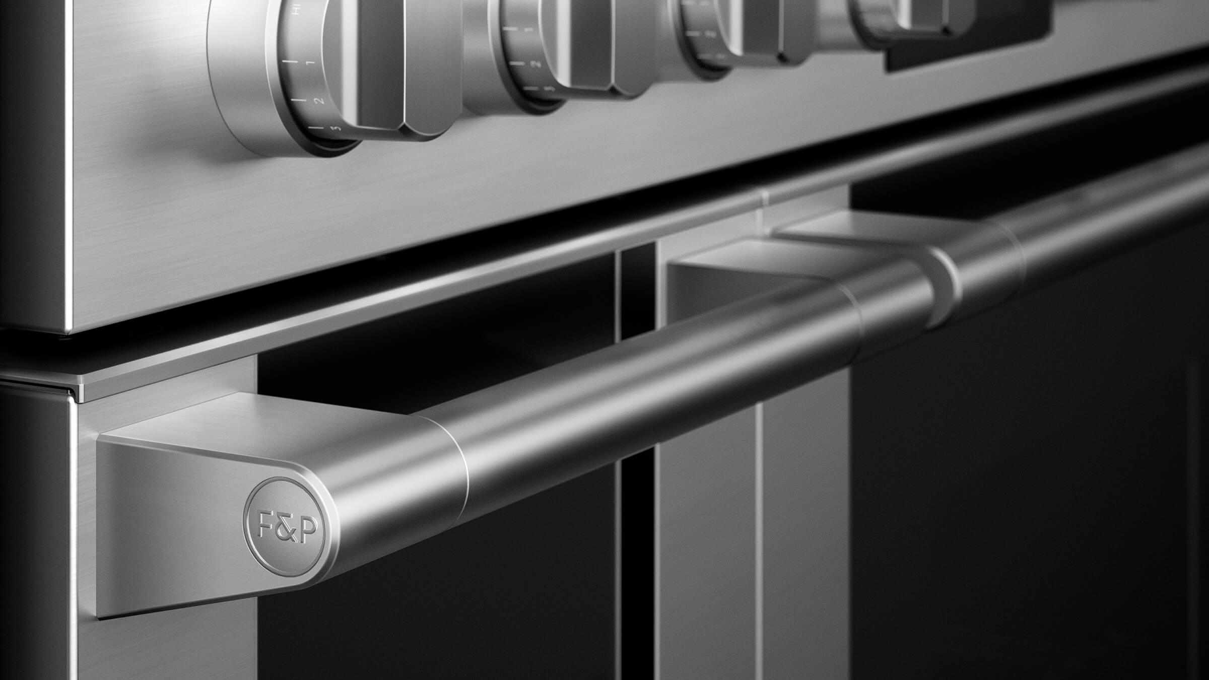 Close-up of a Fisher & Paykel cooker handle and control dial under high heat testing conditions